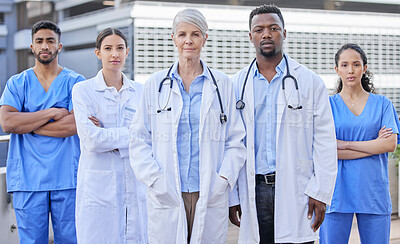 Buy stock photo Shot of a group of doctors standing against a city background