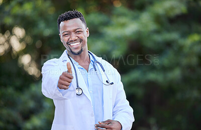 Buy stock photo Shot of a young male doctor showing a thumbs up in nature