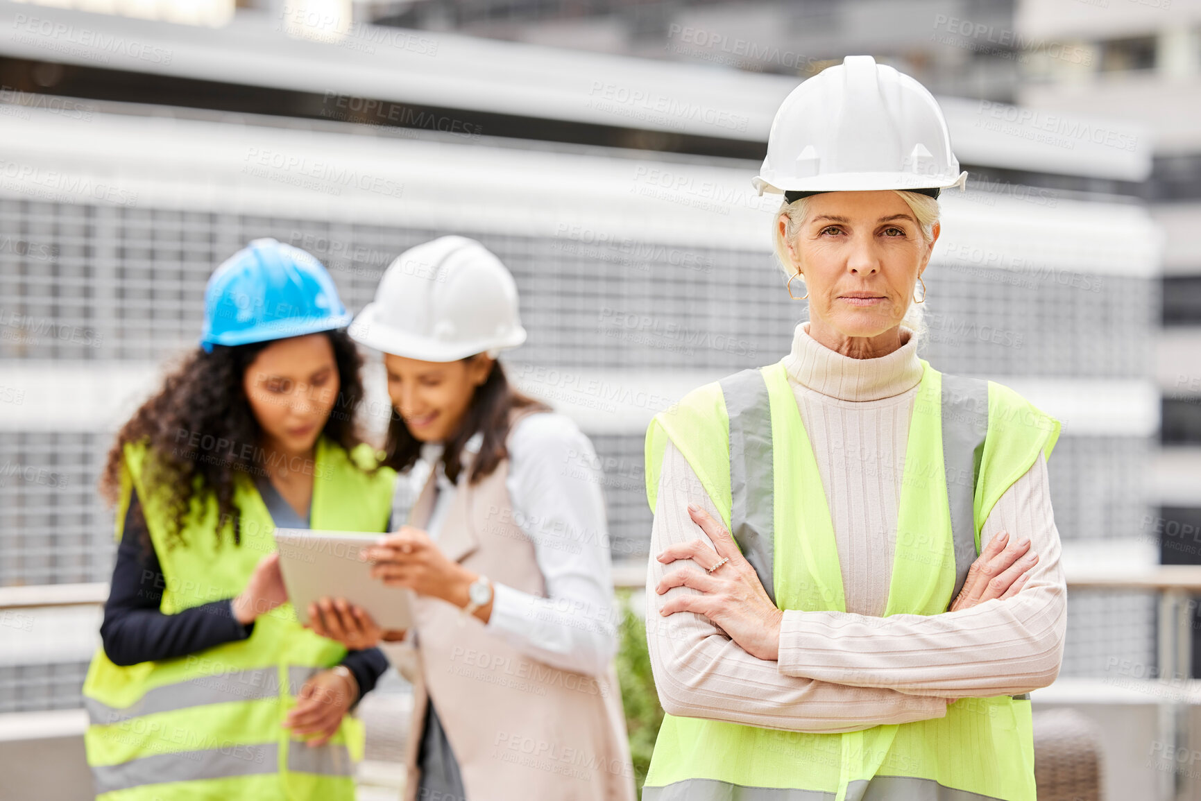 Buy stock photo Mature woman, portrait and professional civil engineer with team in confidence for leadership at site. Female person or executive contractor with arms crossed and hard hat for building construction