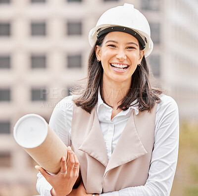 Buy stock photo Cropped portrait of an attractive young female engineer standing with blueprints on a construction site