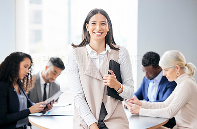 Buy stock photo Shot of a young businesswoman in a meeting with her colleagues