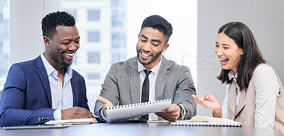Buy stock photo Shot of a team of business people reading through documents during a meeting