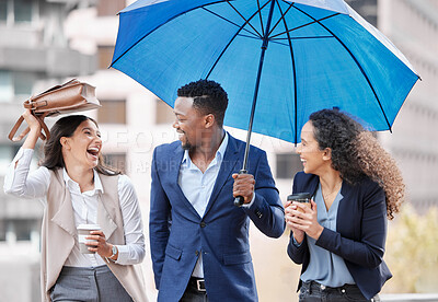 Buy stock photo Shot of a group of businesspeople walking with an umbrella on a rainy day in the city