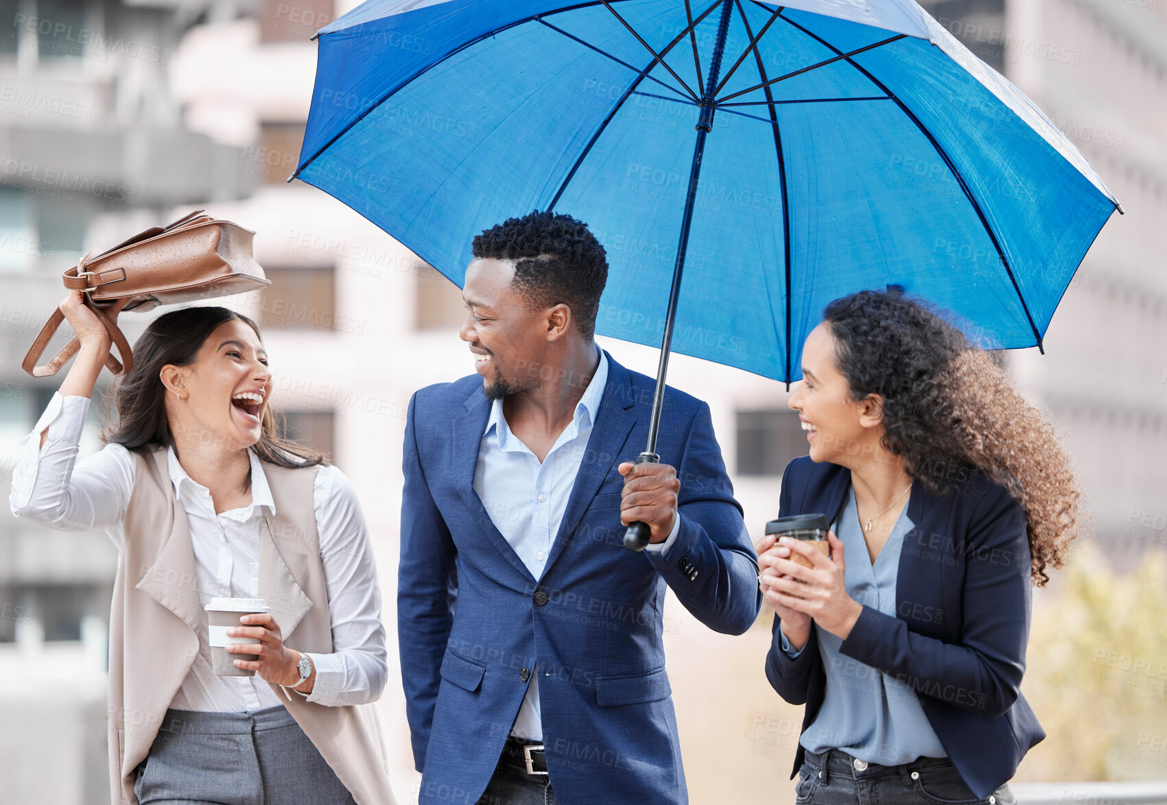 Buy stock photo Happy, business people and umbrella outdoor on rainy day for corporate protection, insurance or global cover. Smiling, group or coworkers together walking and talking for communication and teamwork