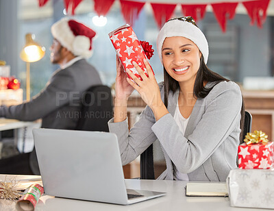 Buy stock photo Shot of a young businesswoman receiving a gift in a modern office at Christmas