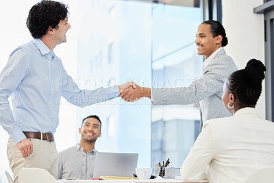 Buy stock photo Shot of a group of people having a meeting and shaking hands in a modern office