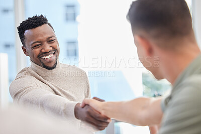 Buy stock photo Shot of two businessmen shaking hands during a meeting in an office