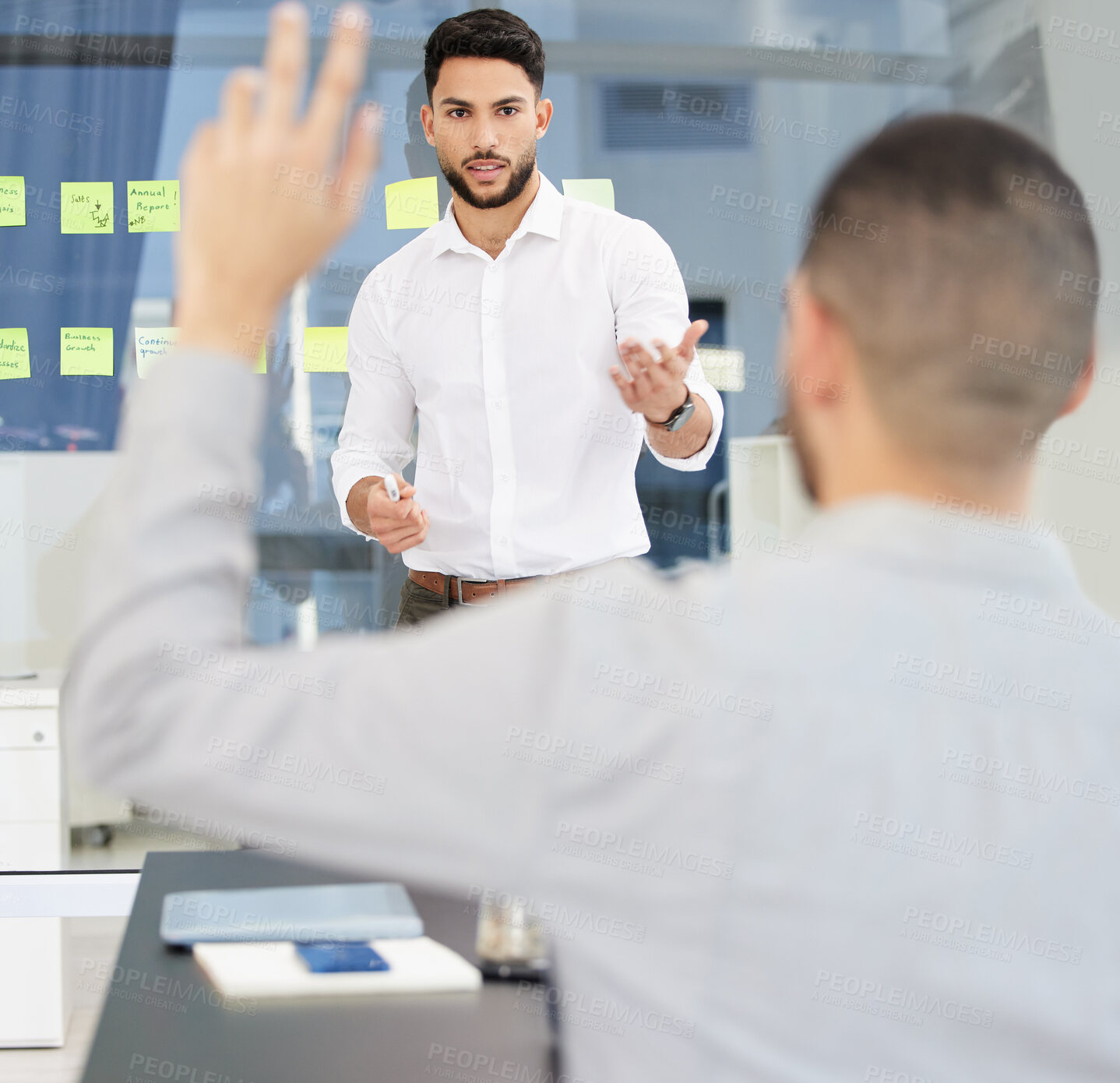 Buy stock photo Shot of a young businessman leading a discussion during a meeting in a boardroom