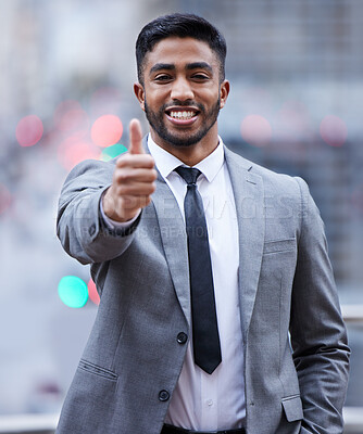 Buy stock photo Shot of a handsome young businessman standing alone and showing a thumbs up