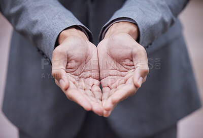 Buy stock photo Cropped shot of an unrecognisable businessman standing alone with his hands cupped
