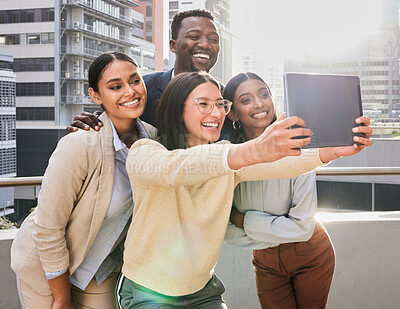 Buy stock photo Cropped shot of a group of young businesspeople using  a tablet to take selfies on an office balcony