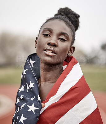 Buy stock photo Shot of a beautiful young female athlete with the american flag wrapped around herself