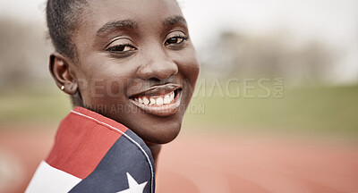 Buy stock photo Shot of a beautiful young female athlete with the american flag wrapped around herself