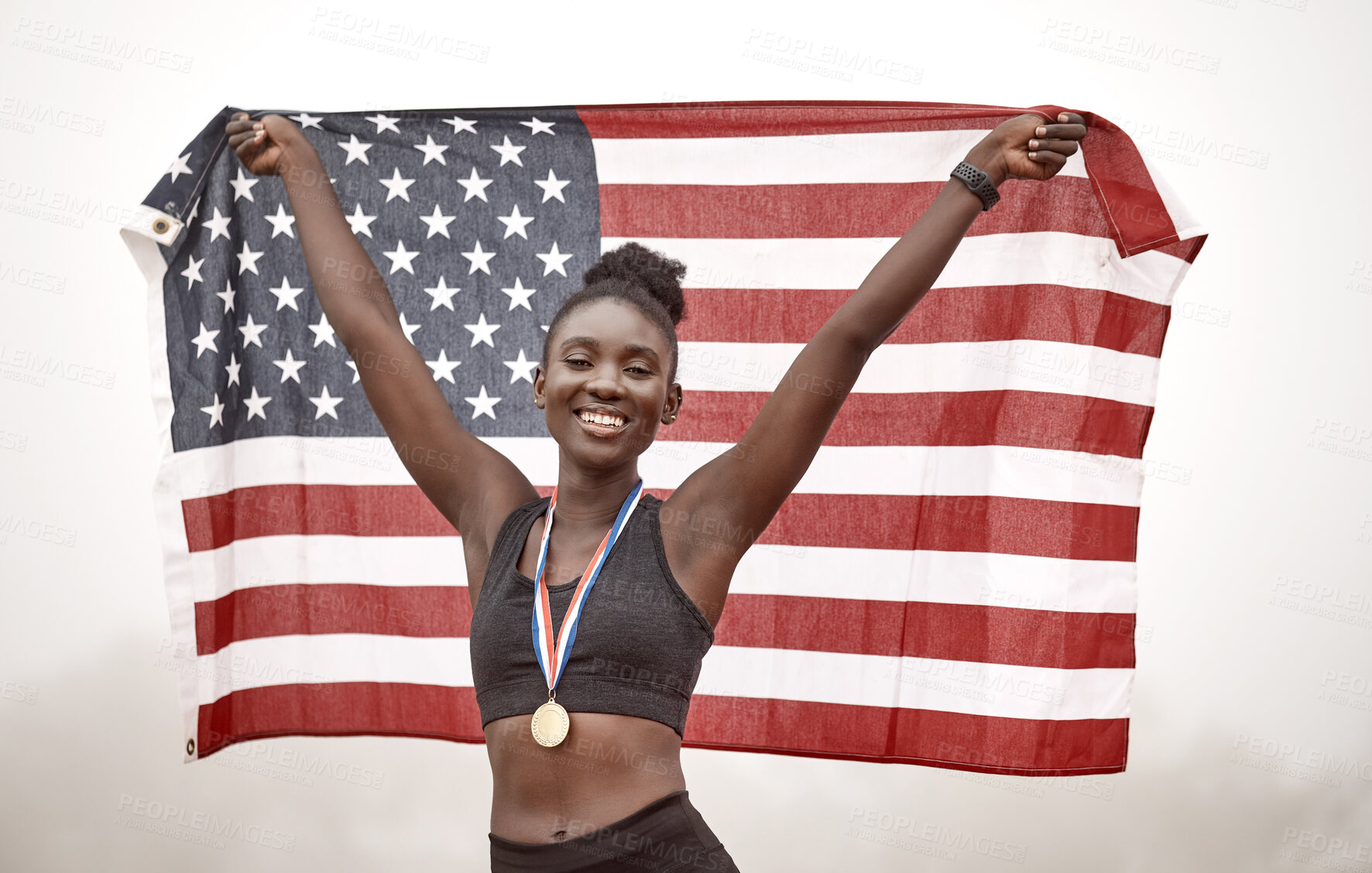 Buy stock photo Shot of a young female athlete celebrating her win while running with a flag