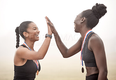 Buy stock photo Shot of two athletes high fiving one another