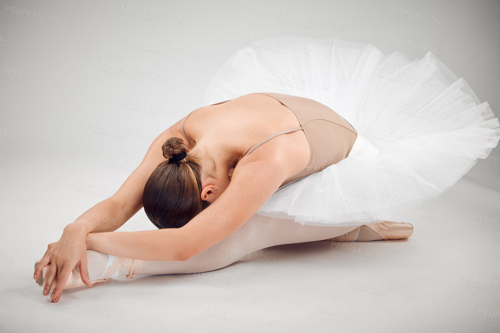 Buy stock photo Ballet, stretching and woman in studio for dance with art career performance, concert or recital. Creative, girl and ballerina with warm up exercise for classical moving practice by white background.