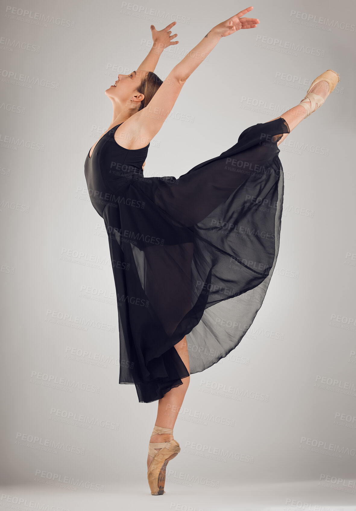 Buy stock photo Full length shot of an attractive young female ballet dancer in studio against a grey background