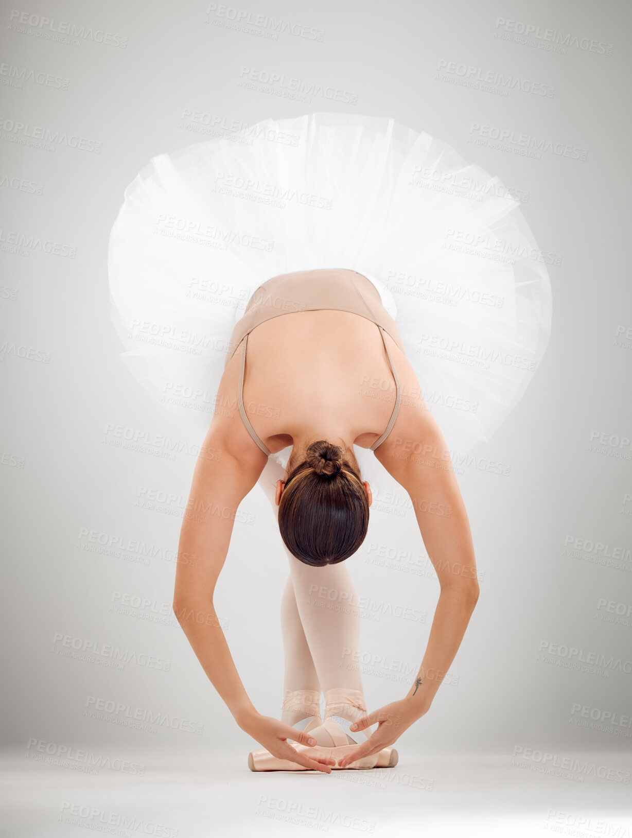 Buy stock photo Ballet, dancing and woman in studio with pose for career with performance, concert or recital. Creative, art and ballerina with warm up exercise for classical moving practice by gray background.