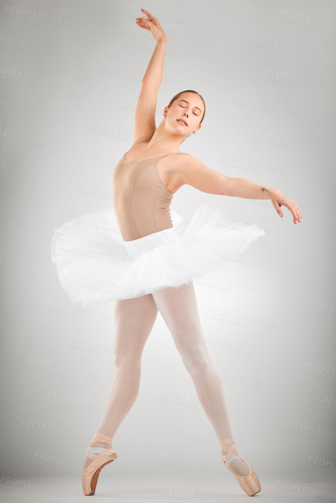 Buy stock photo Ballet, dance and ballerina in studio with art career stretching for theater, concert or recital. Creative, pose and woman classical performer with moving for balance practice by gray background.