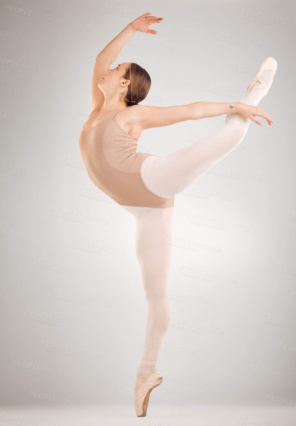 Buy stock photo Full length shot of an attractive young female ballet dancer in studio against a grey background
