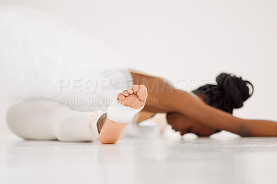 Buy stock photo Shot of a dancer stretching in a studio