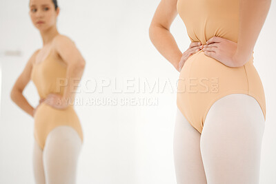 Buy stock photo Shot of a young ballet dancer inspecting her figure in a mirror during a rehearsal