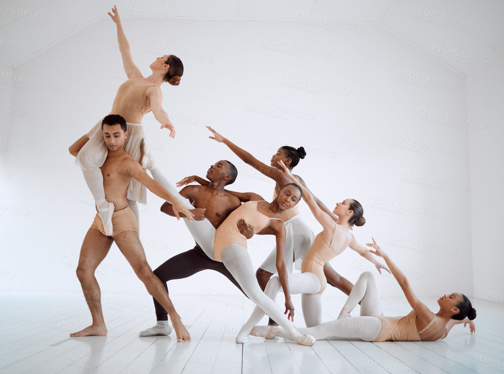 Buy stock photo Shot of a group of ballet dancers practicing a routine in a dance studio