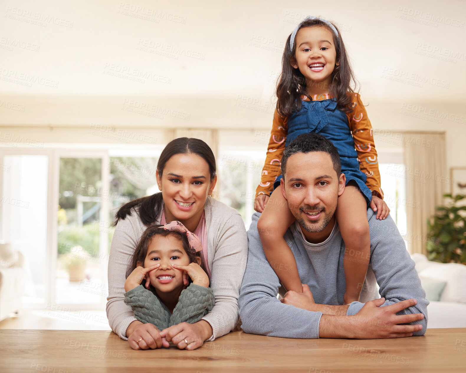 Buy stock photo Happy family, parents and girls with portrait in home for bonding, support and security with confidence. People, children and relax in living room with embrace, trust and hugging with love in house