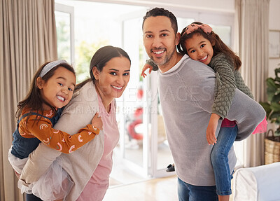 Buy stock photo Shot of a young mother and father giving their daughters piggyback rides