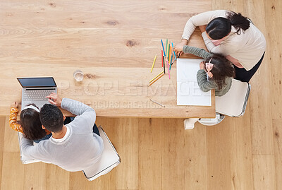 Buy stock photo Shot of two parents helping their children with their homework