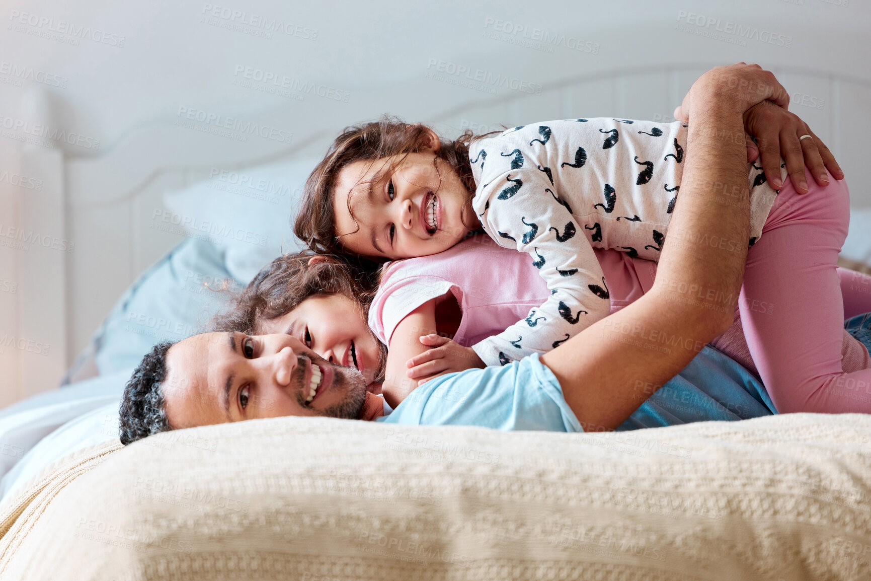 Buy stock photo Shot of two little girls lying on top of their father