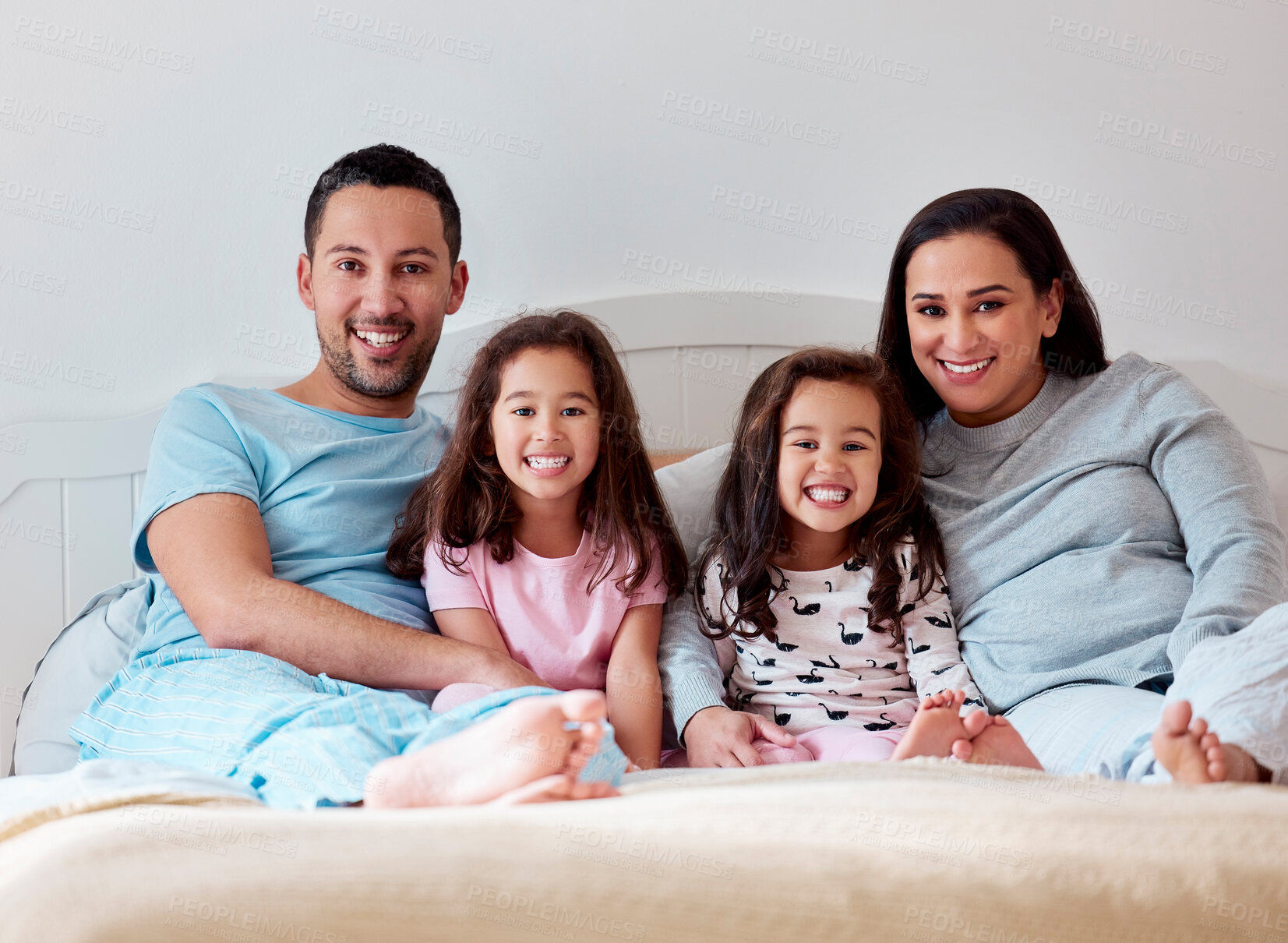 Buy stock photo Family, portrait and relax in bedroom at house with hug, love and bonding for playing game of morning care. Smile, parents and children for embrace of security, connection and trust together at home