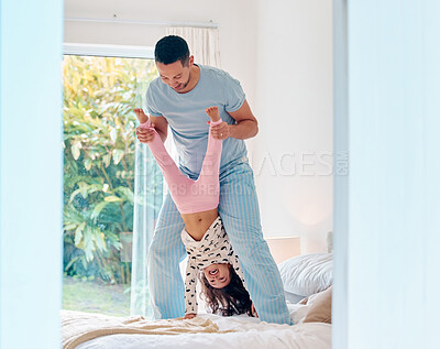 Buy stock photo Shot of a man playing with his daughter at home