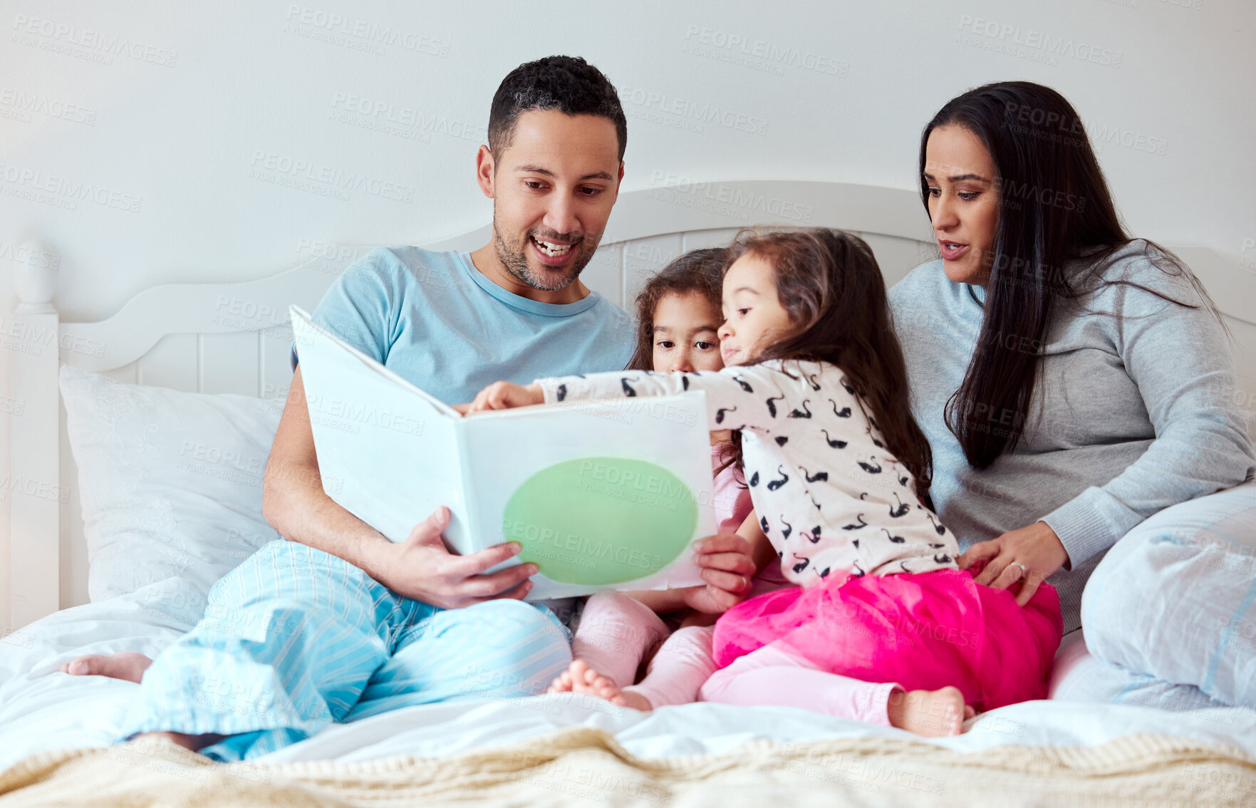 Buy stock photo Parents, girls and family with storytelling on bed at home for fun, bonding and care with education. Home, people and kids with learning on book reading for knowledge, information and child growth