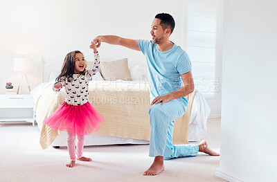 Buy stock photo Shot of a man dancing with his young daughter at home