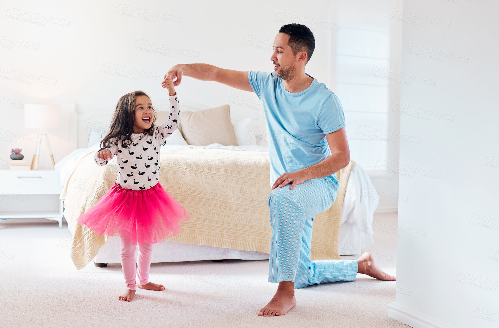 Buy stock photo Shot of a man dancing with his young daughter at home