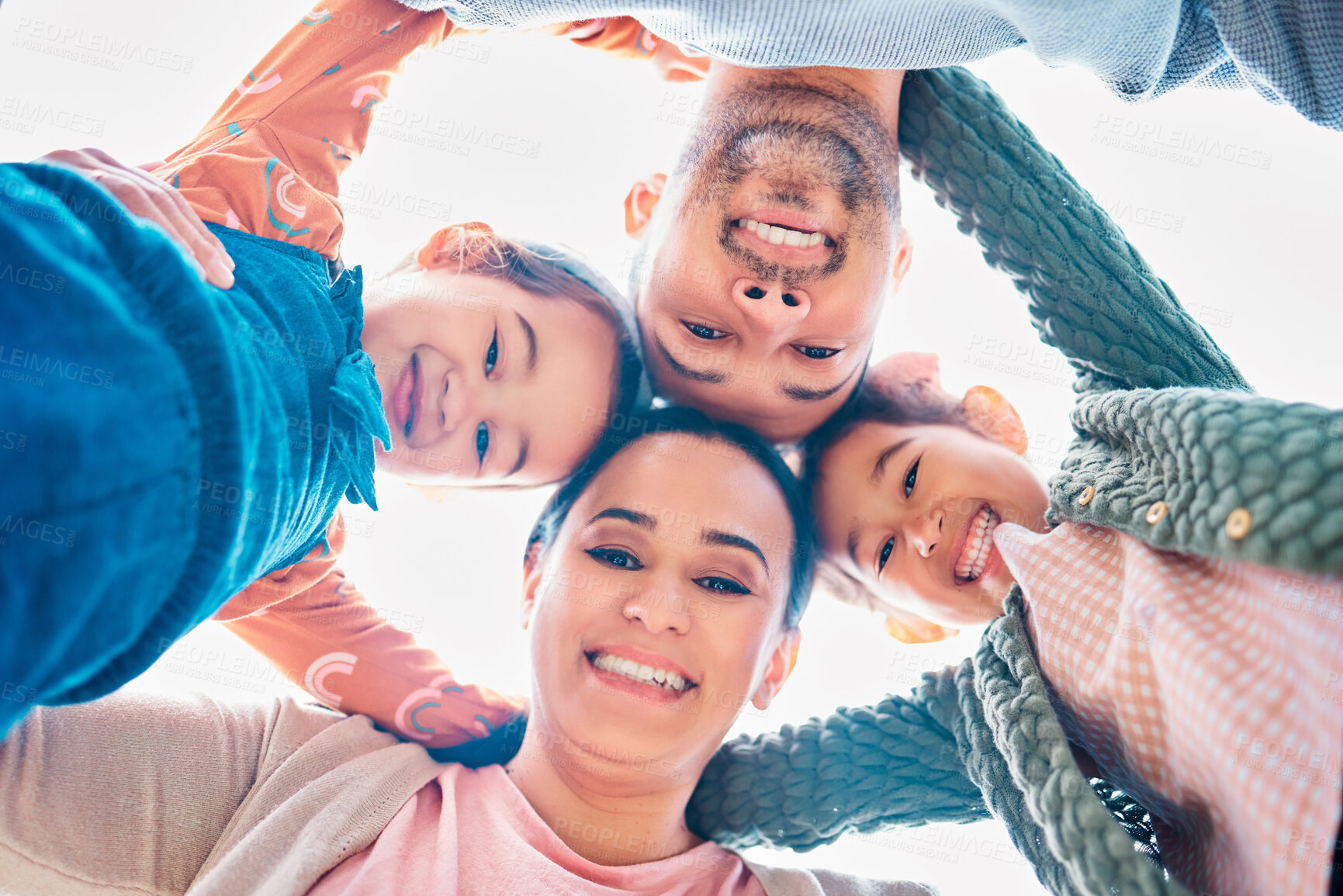 Buy stock photo Smile, huddle and portrait of family with support, blue sky and bonding together in nature. Low angle, face and parents with man and woman for childhood, solidarity and fun or joy with embrace