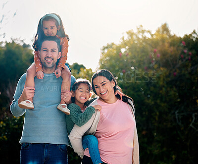 Buy stock photo Shot of a young family spending time together in a park