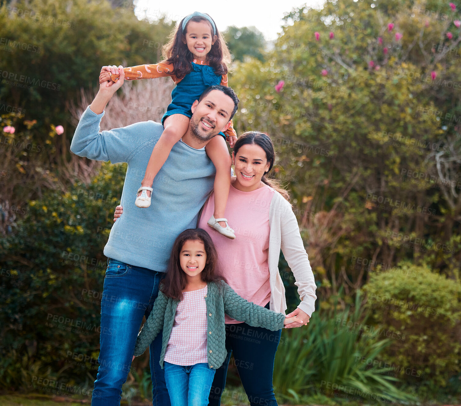 Buy stock photo Shot of a young family spending time together in a park