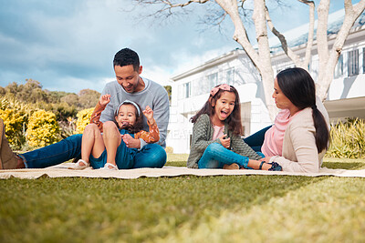 Buy stock photo Shot of a young family having a picnic in a park
