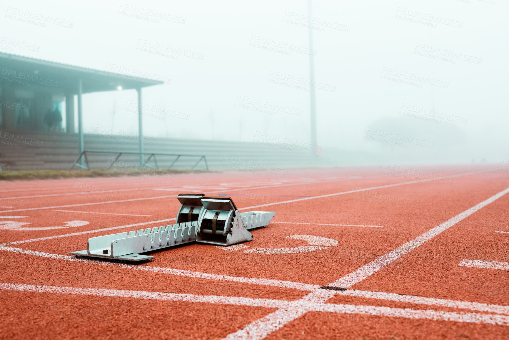 Buy stock photo Starting blocks, track and outdoor at stadium for race, sprint or international competition in fog. Metal equipment, running and ground for global games, speed or launch in mist for contest in Paris