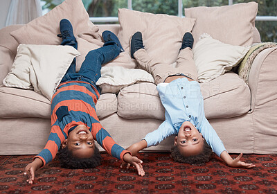 Buy stock photo Portrait of two little boys lying upside down on a sofa at home