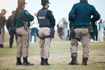 Buy stock photo Security, riot and protest with police officer in park for law enforcement, protection or safety. Brave, uniform and government with people in street for demonstration rally, human rights or control 