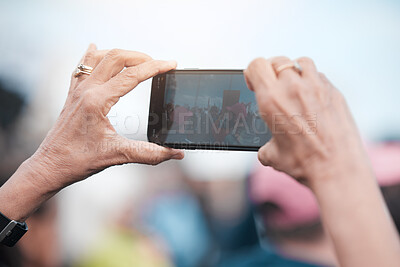 Buy stock photo Hands, phone screen and person taking photograph outdoor for protest, climate change or global warming. Lens flare, rally and woman with mobile for pollution, human rights or fight for our planet 