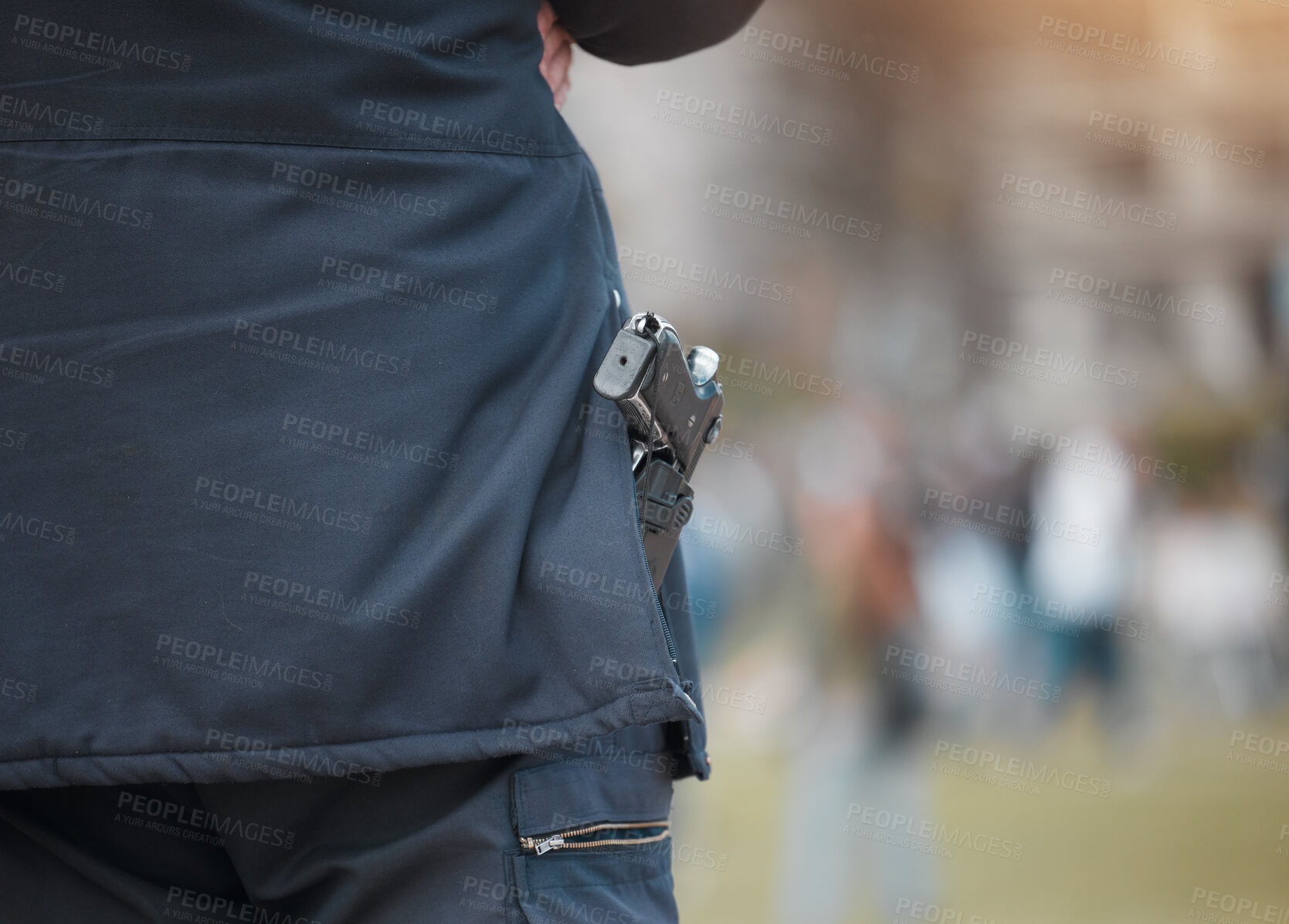 Buy stock photo Police, person and gun with back at protest with safety, monitor and outdoor for crowd control in city. Security guard, weapon and government agent in road, street and protection for danger at rally