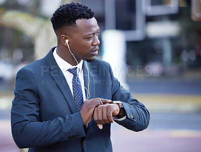 Buy stock photo Watch, earphones and black man in city walking to work listening to music, radio or podcast. Time, serious and professional African male lawyer commuting to job with legal career in urban town.