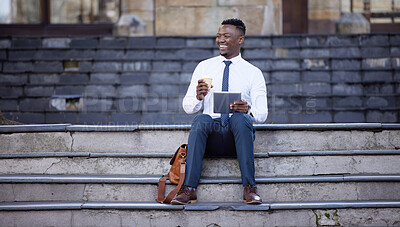 Buy stock photo Shot of a young businessman using a digital tablet in the city
