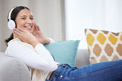 Buy stock photo Shot of a young woman listening to music at home