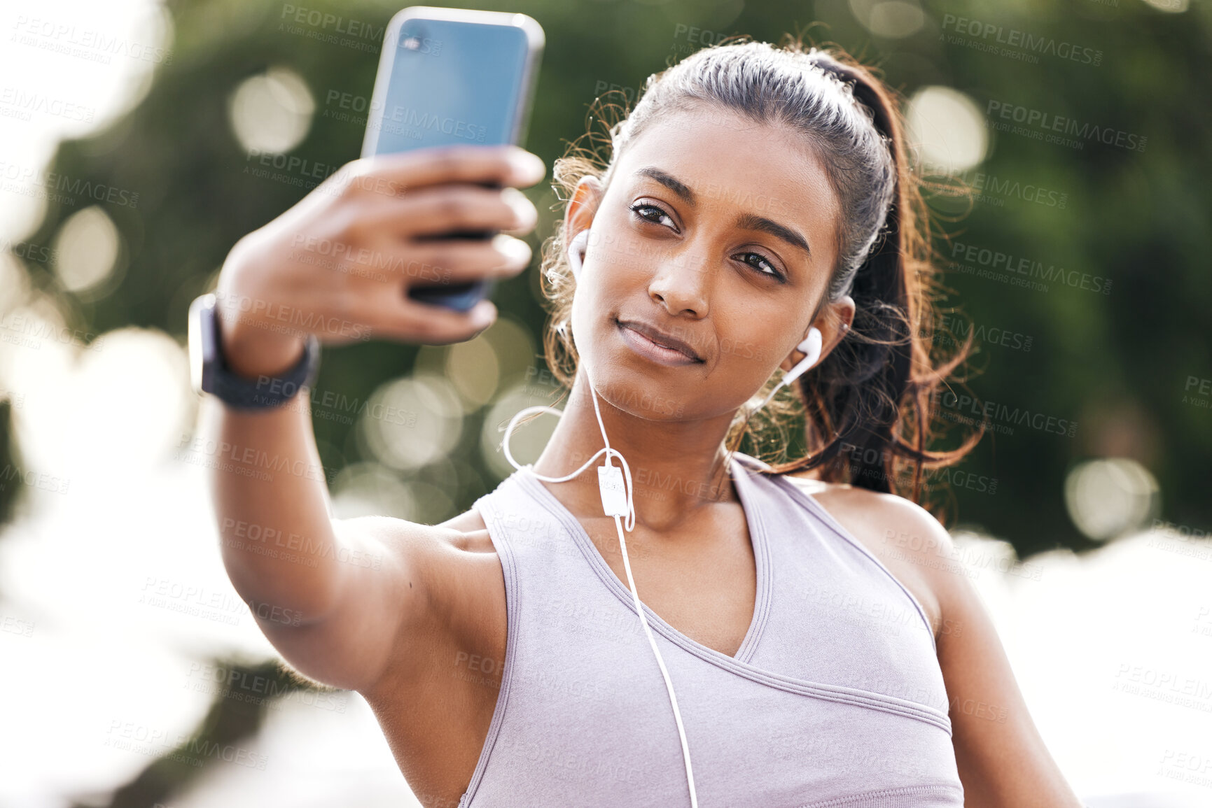 Buy stock photo Selfie, earphones and woman athlete in nature for health, wellness or body workout listen to music. Smile, outdoor and Indian female person with photography picture for exercise or training in park.