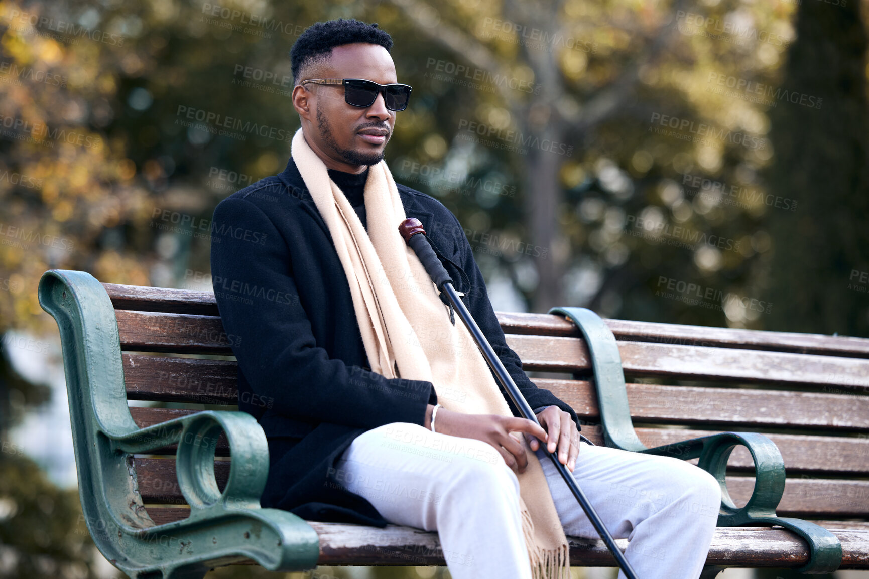 Buy stock photo Blind black man, park and sitting with sunglasses, walking stick and relax by trees, peace and thinking. African guy, vintage fashion and young person with disability, glasses and travel in nature